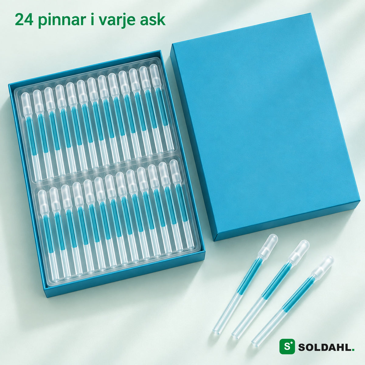 Öppen ask med 24 pinnar i bricka och tre lösa pinnar, texten 24 pinnar i varje ask