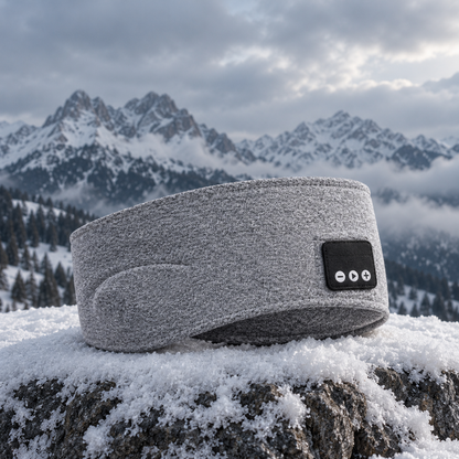 Grått Bluetooth-pannband på en snötäckt sten i fjällen