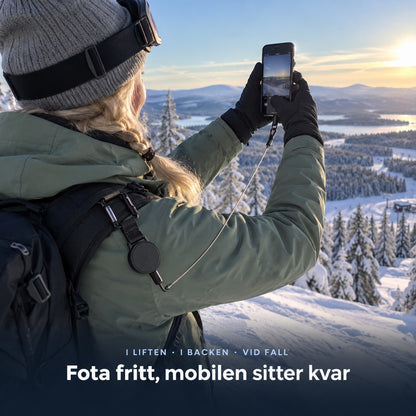 Kvinna fotar fjällutsikten, wiren sträckt från rullen på jackan